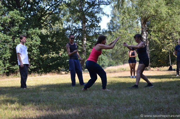 Nadja and Kyra  practicing Taikiken light sparring in the outdoor dojo.