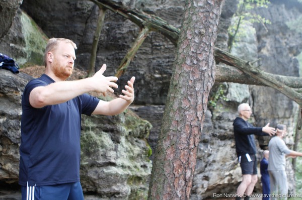 Standing Zen on the edge with with ancient rocks in the back
